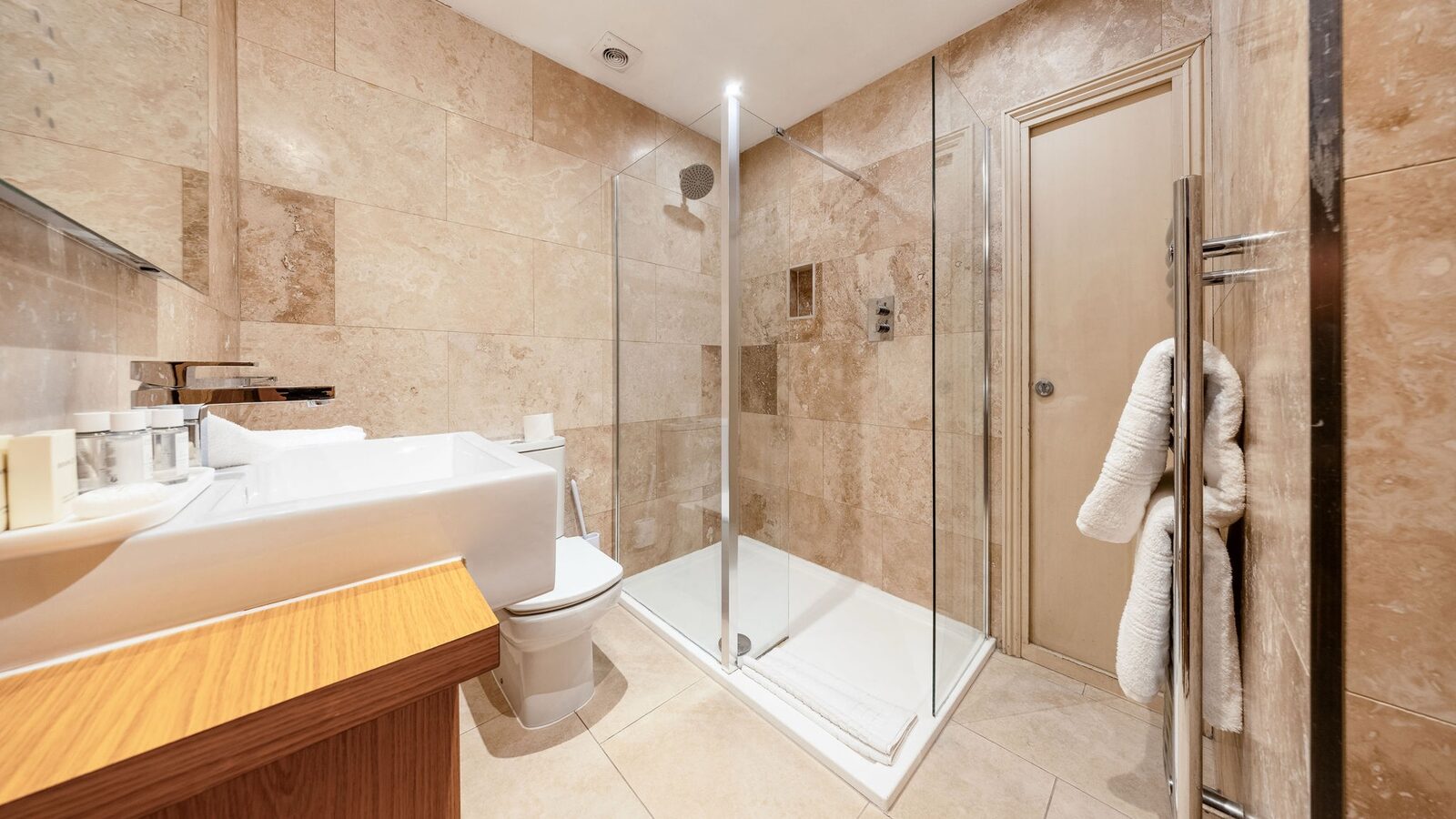 Walk-in shower, travertine surround